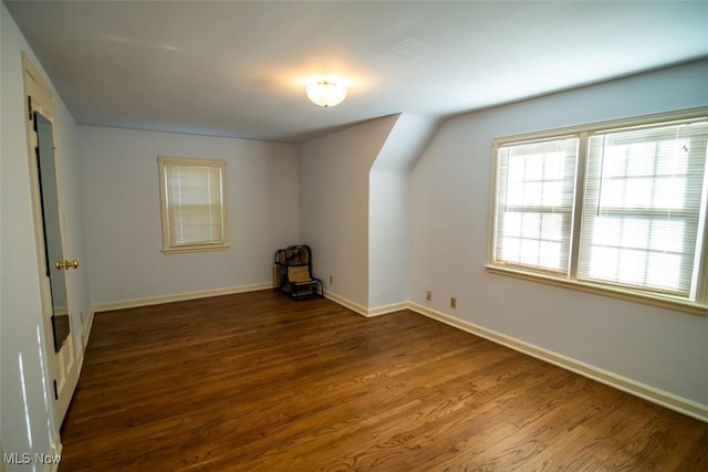 bonus room with dark wood-type flooring