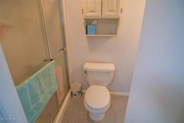 bathroom with tile patterned floors, an enclosed shower, and toilet