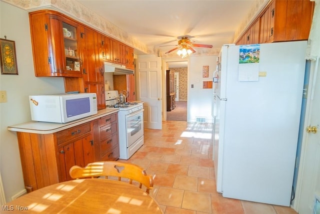 kitchen featuring ceiling fan, white appliances, and light tile patterned floors