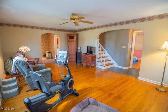 workout area with ceiling fan and hardwood / wood-style floors