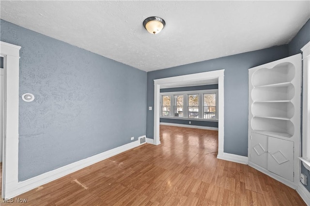 interior space featuring hardwood / wood-style floors and a textured ceiling