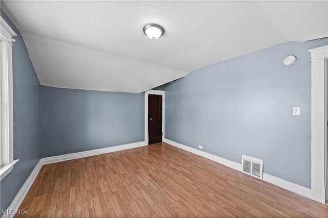 bonus room featuring light wood-type flooring and lofted ceiling