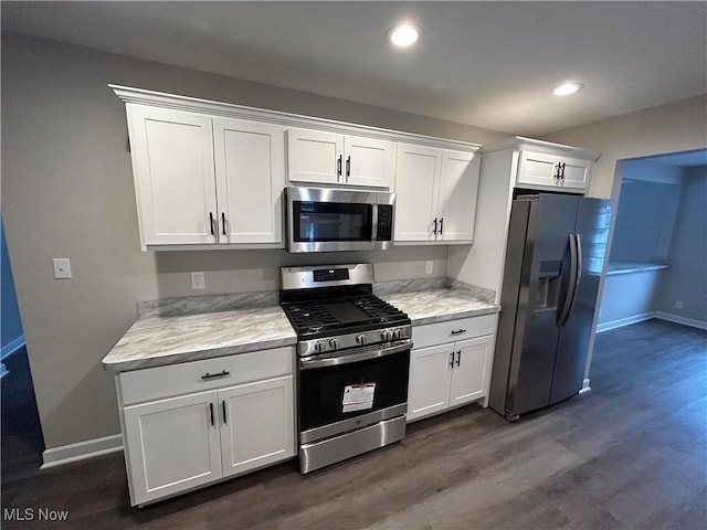 kitchen featuring white cabinets, stainless steel appliances, and dark hardwood / wood-style floors