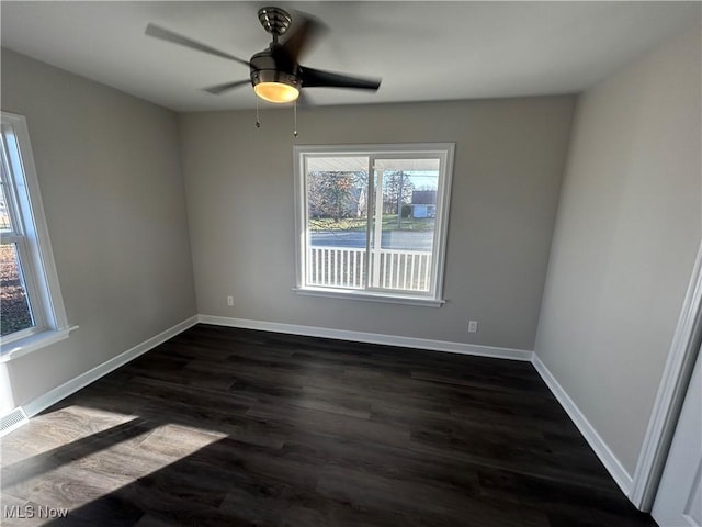 unfurnished room featuring dark hardwood / wood-style floors and ceiling fan