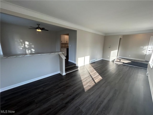 unfurnished living room featuring crown molding, ceiling fan, and dark hardwood / wood-style floors