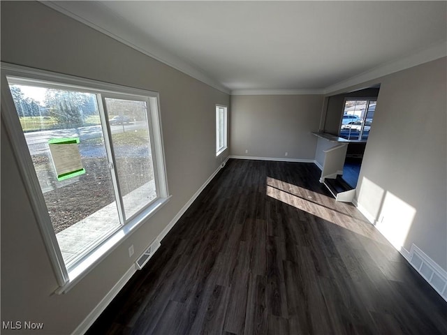 unfurnished living room with crown molding and dark wood-type flooring