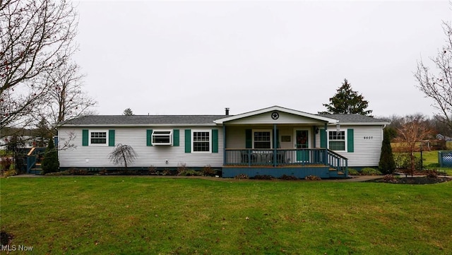 ranch-style house with a front yard, a porch, and a wall mounted air conditioner