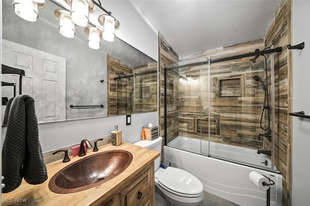 full bathroom featuring shower / bath combination with glass door, vanity, a textured ceiling, and toilet