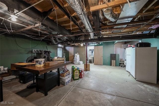 basement with white refrigerator