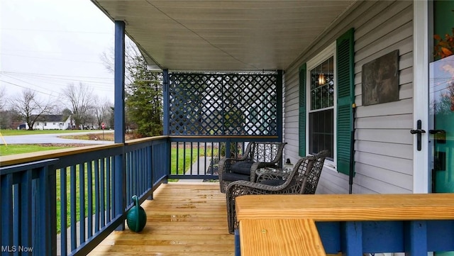 wooden terrace with a porch