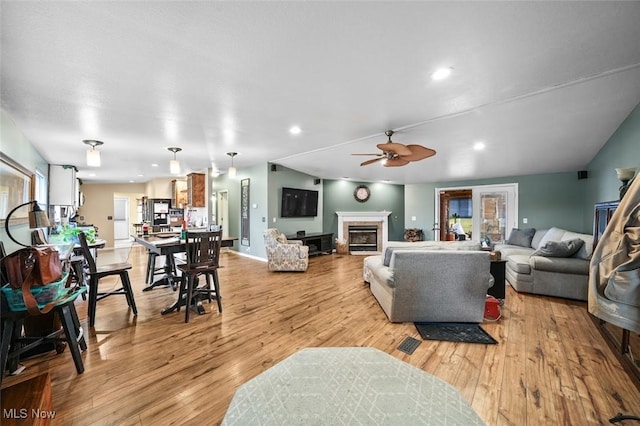 living room featuring light wood-type flooring and ceiling fan