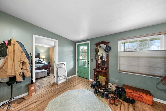 entryway with light hardwood / wood-style flooring and vaulted ceiling