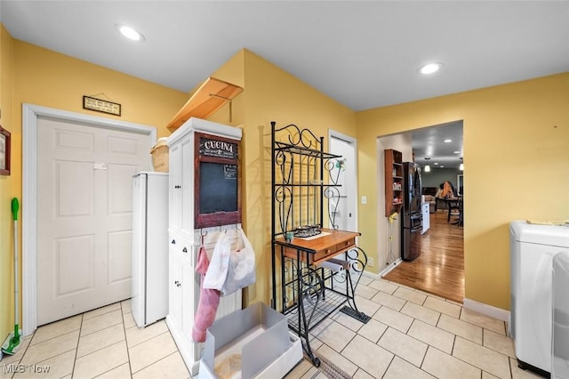 interior space featuring washer / clothes dryer and light hardwood / wood-style flooring