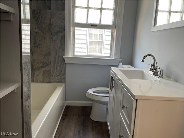 bathroom with hardwood / wood-style floors, vanity, and toilet