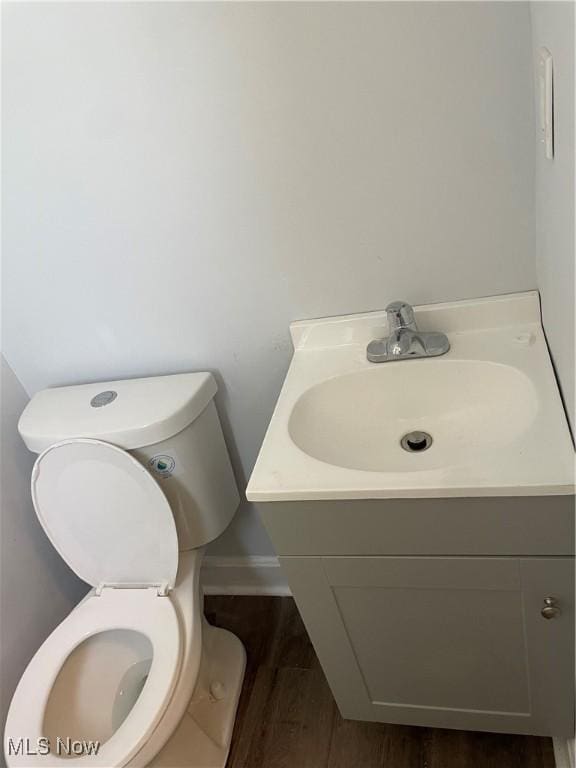 bathroom featuring hardwood / wood-style flooring, vanity, and toilet