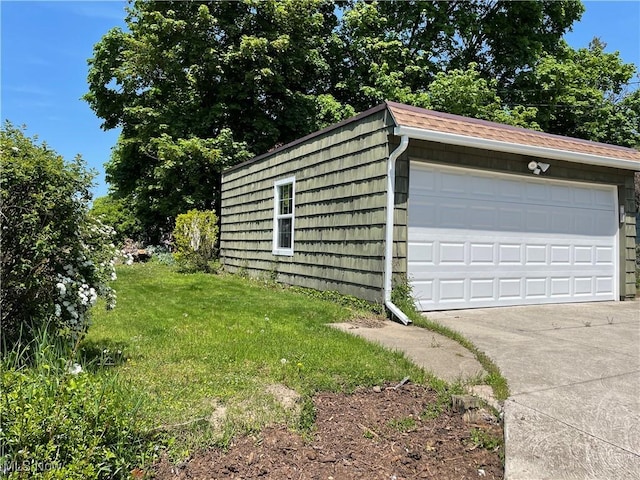 garage featuring a lawn