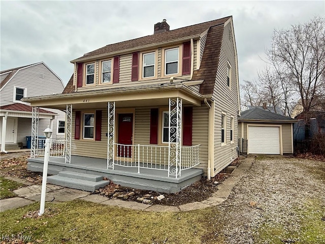 view of front of home featuring a porch, a garage, and an outbuilding