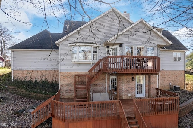 back of property featuring central AC and a deck