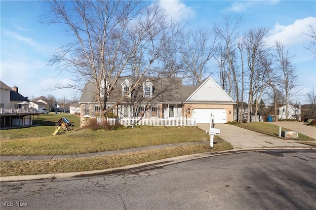 new england style home featuring a porch, a garage, and a front yard