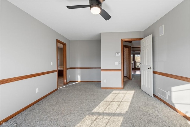 carpeted empty room with ceiling fan