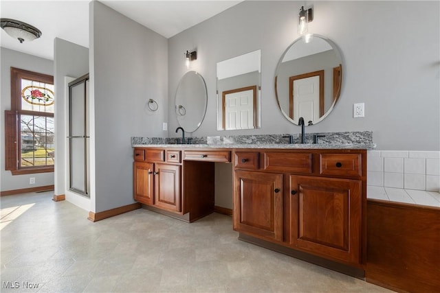 bathroom featuring vanity and a shower with shower door