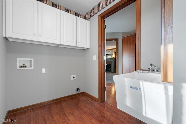 washroom with dark hardwood / wood-style flooring, hookup for a washing machine, cabinets, and hookup for an electric dryer