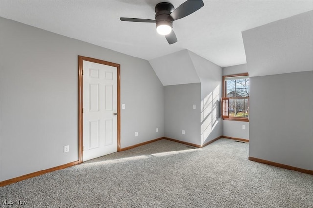 bonus room featuring ceiling fan, light colored carpet, and lofted ceiling