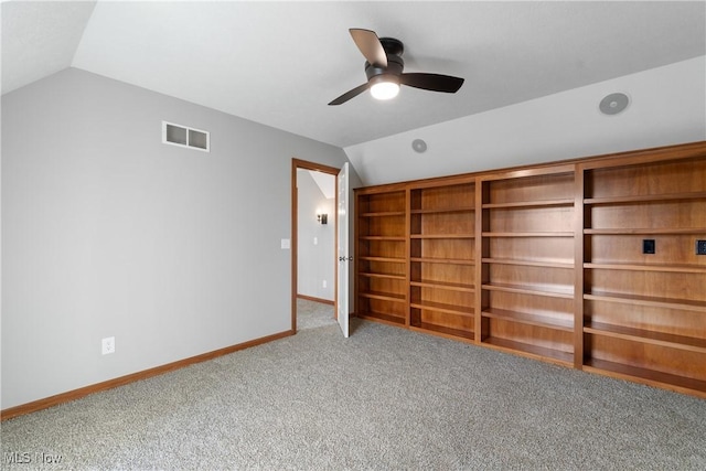 unfurnished bedroom with ceiling fan, carpet floors, and vaulted ceiling