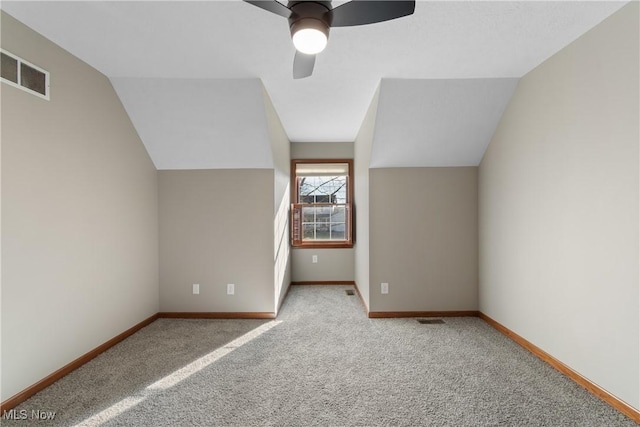 bonus room featuring light carpet, vaulted ceiling, and ceiling fan