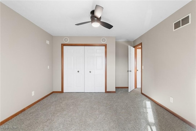 unfurnished bedroom featuring carpet flooring, ceiling fan, and a closet