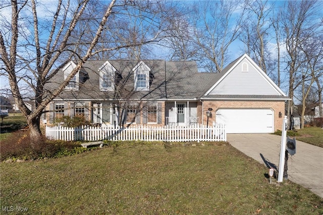 cape cod home featuring a front yard and a garage