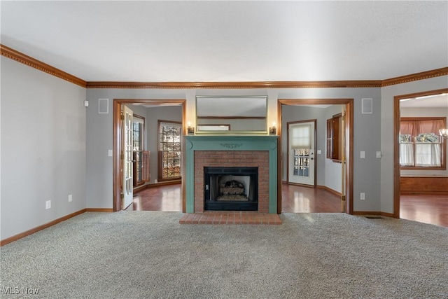 unfurnished living room with carpet, a brick fireplace, and a wealth of natural light