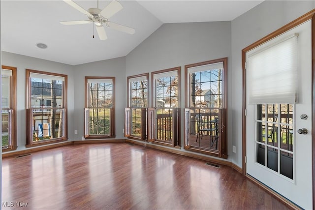 unfurnished sunroom featuring vaulted ceiling, a wealth of natural light, and ceiling fan