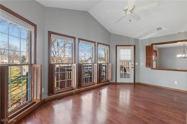 unfurnished room featuring ceiling fan with notable chandelier, dark hardwood / wood-style flooring, and lofted ceiling