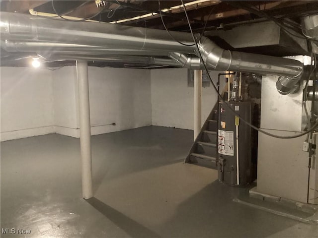 basement featuring heating unit and water heater