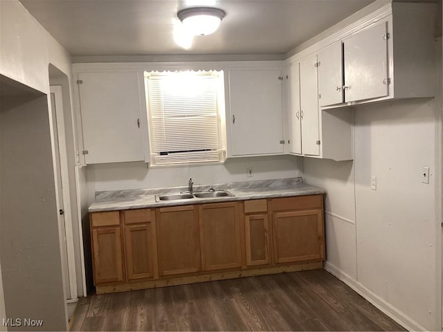 kitchen featuring white cabinets, dark hardwood / wood-style floors, and sink