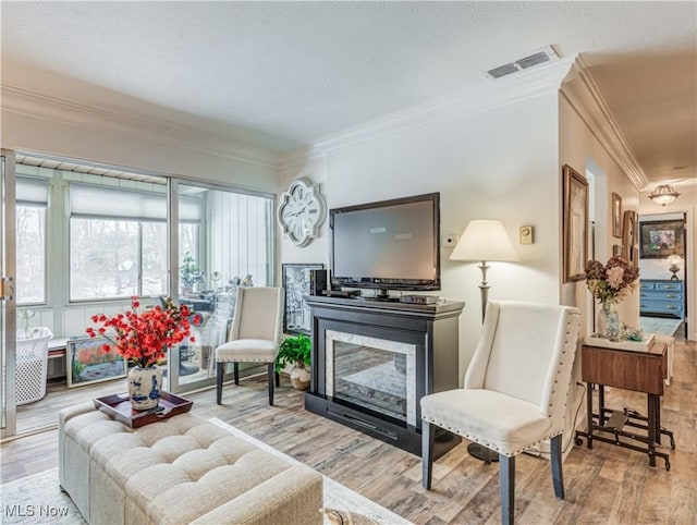 living room with ornamental molding and wood-type flooring