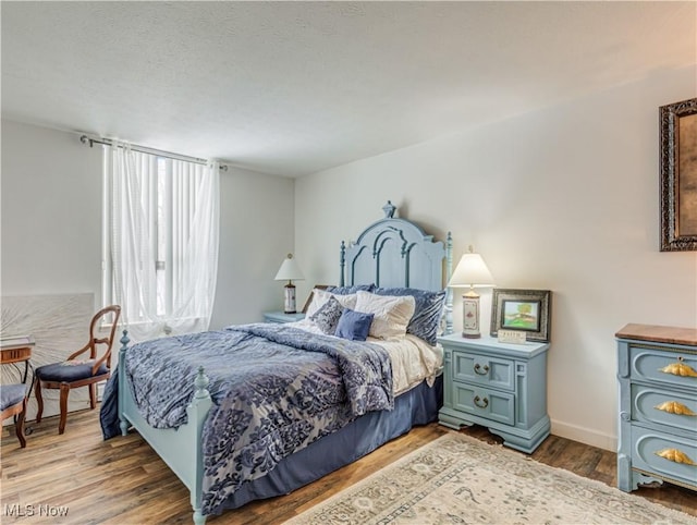 bedroom with wood-type flooring