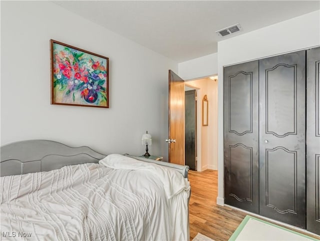 bedroom featuring light hardwood / wood-style floors and a closet