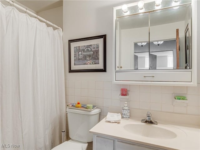 bathroom featuring vanity, toilet, and a shower with shower curtain