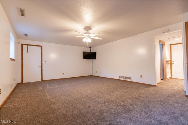 spare room with ceiling fan and carpet