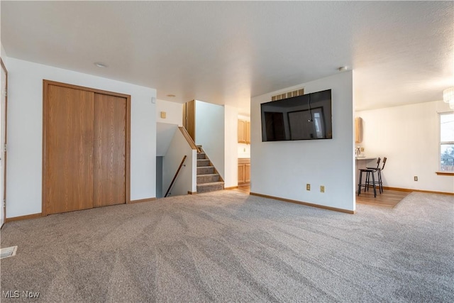 unfurnished living room with carpet floors