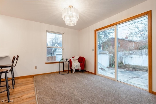 sitting room featuring a notable chandelier and light hardwood / wood-style floors