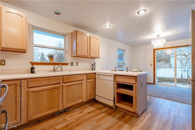 kitchen featuring an inviting chandelier, white dishwasher, sink, light brown cabinetry, and light hardwood / wood-style floors