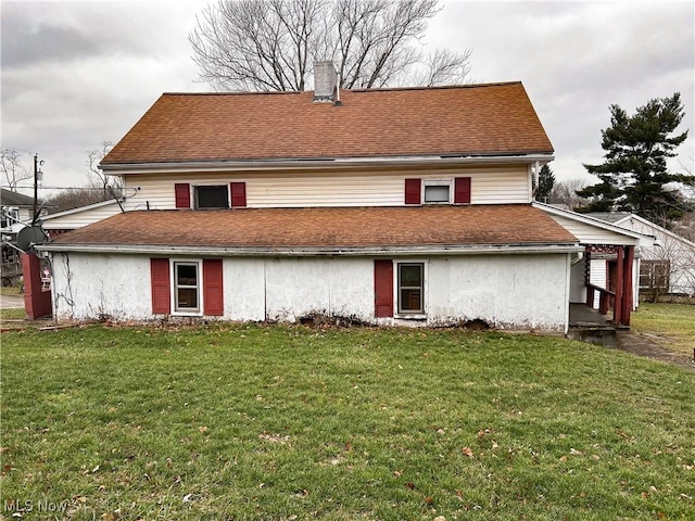 rear view of house with a lawn