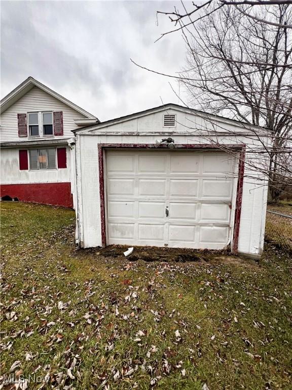 garage featuring a yard