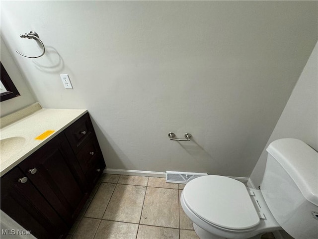 bathroom featuring tile patterned flooring, vanity, and toilet