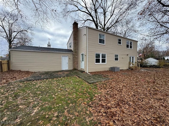 rear view of property featuring a yard, a patio, and central AC unit