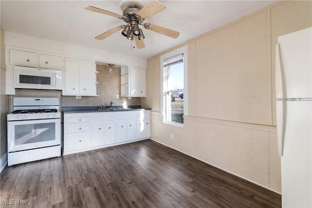 kitchen featuring white appliances, backsplash, sink, dark hardwood / wood-style floors, and white cabinetry