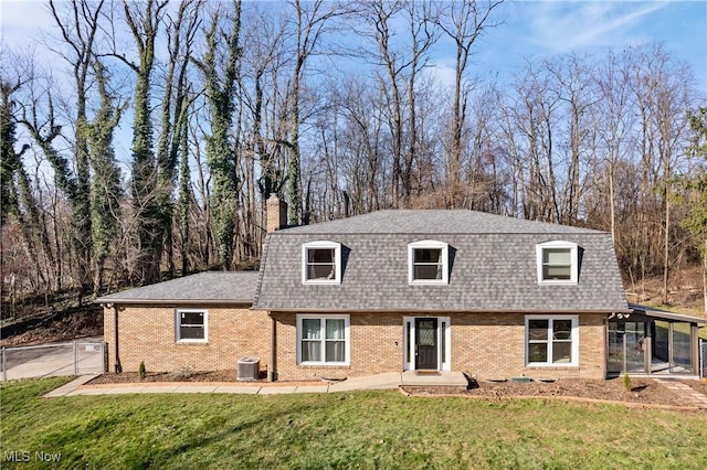 view of front of home with central AC, a front lawn, and a sunroom